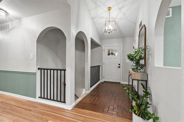 1803 N Jeter Rd, Raymore, MO 64083 - foyer entrance featuring a chandelier and brick flooring
