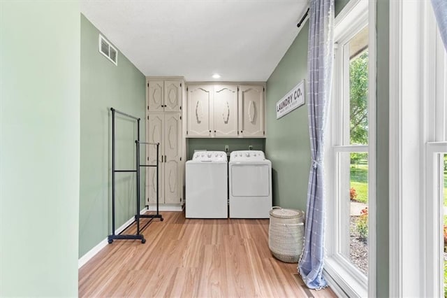 1803 N Jeter Rd, Raymore, MO 64083 - laundry area featuring cabinet space, independent washer and dryer, and light wood-style flooring