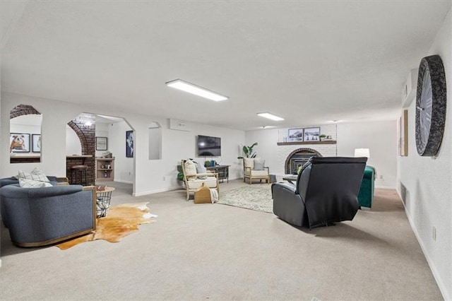 1803 N Jeter Rd, Raymore, MO 64083 - carpeted living area with a fireplace and arched walkways
