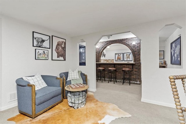 1803 N Jeter Rd, Raymore, MO 64083 - living area with carpet flooring and arched walkways
