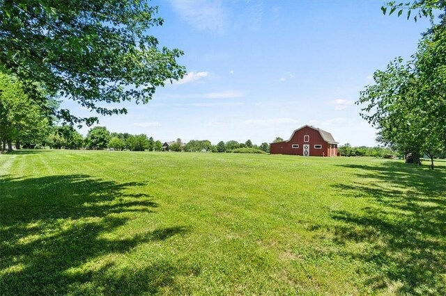 1803 N Jeter Rd, Raymore, MO 64083 - view of grassy yard with a barn, an outbuilding, and a view of countryside