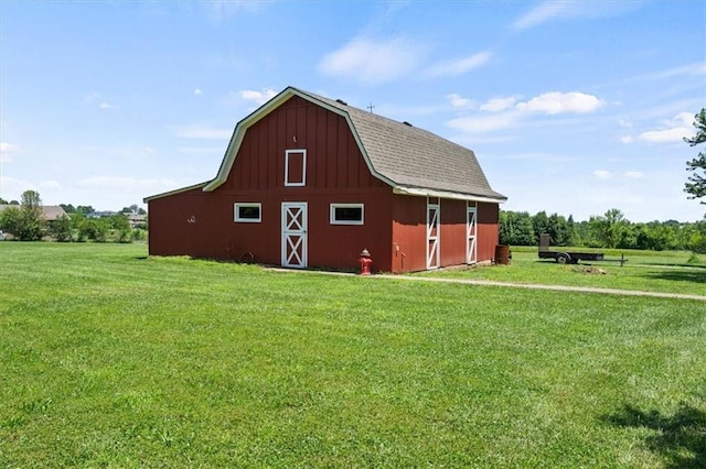 1803 N Jeter Rd, Raymore, MO 64083 - view of property exterior with a barn, a gambrel roof, an outdoor structure, and a lawn