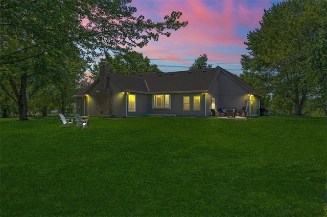1803 N Jeter Rd, Raymore, MO 64083 - rear view of property with a chimney and a lawn