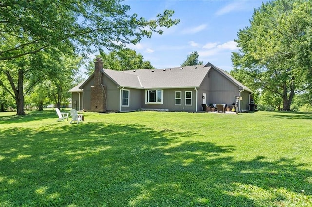 1803 N Jeter Rd, Raymore, MO 64083 - rear view of house with a chimney, a lawn, and a patio