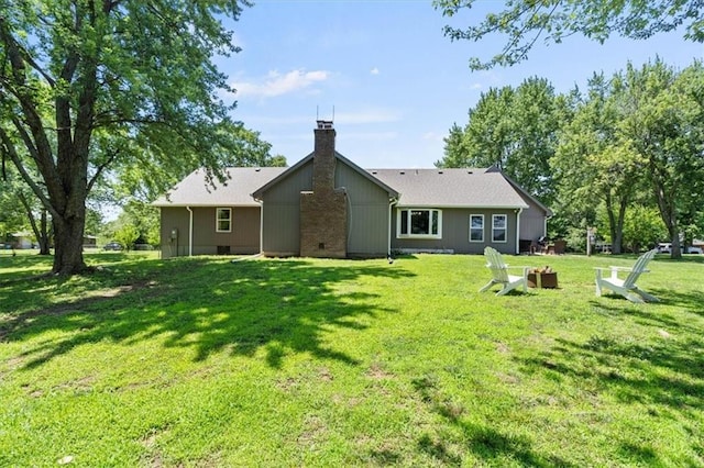 1803 N Jeter Rd, Raymore, MO 64083 - back of house featuring a chimney and a lawn