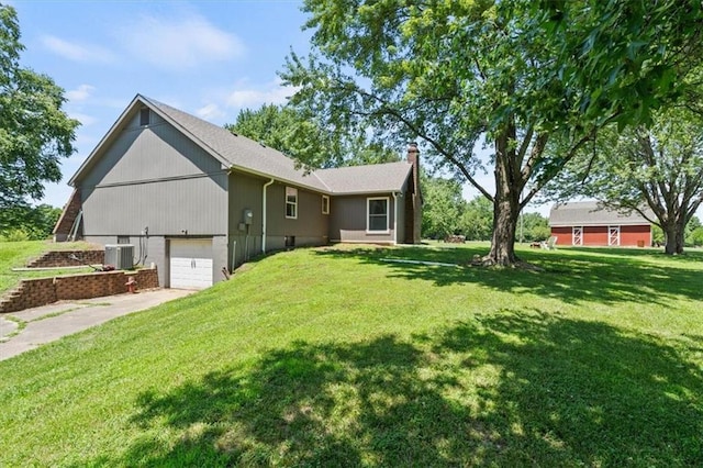 1803 N Jeter Rd, Raymore, MO 64083 - view of front of property featuring a chimney, driveway, and a front yard