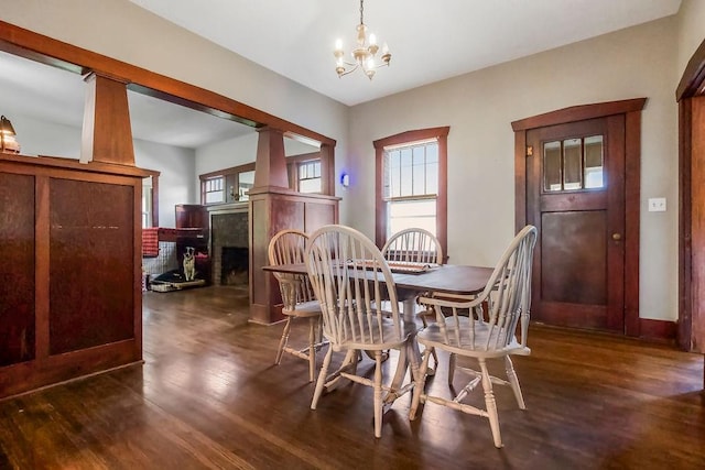 327 Parker Ave, Osawatomie, KS 66064 - dining space featuring a chandelier, dark wood-style floors, and plenty of natural light
