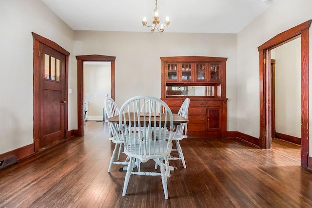 327 Parker Ave, Osawatomie, KS 66064 - dining area featuring dark wood-style floors and a chandelier