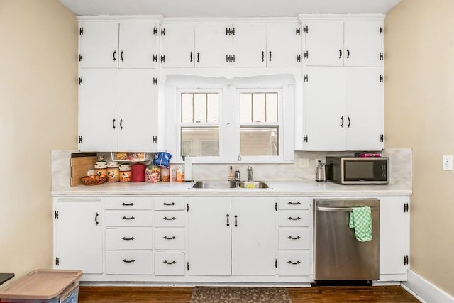 327 Parker Ave, Osawatomie, KS 66064 - kitchen with stainless steel appliances, light countertops, white cabinets, and dark wood-style flooring