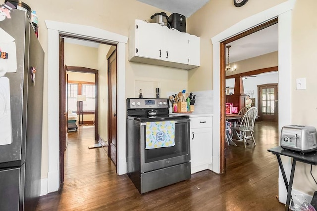 327 Parker Ave, Osawatomie, KS 66064 - kitchen featuring appliances with stainless steel finishes, dark wood-style flooring, healthy amount of natural light, and white cabinetry