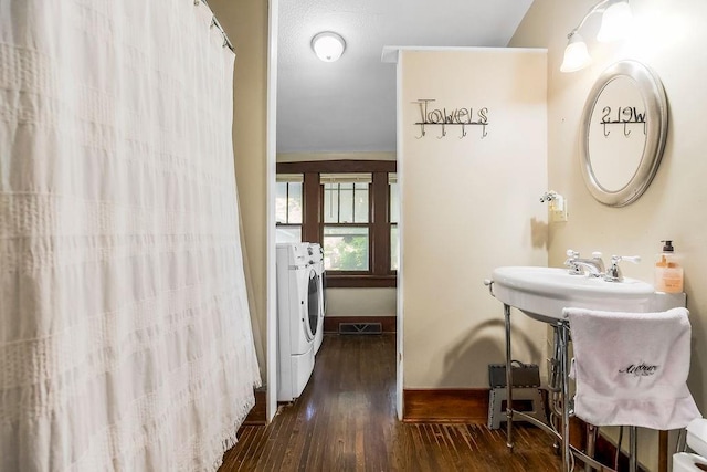 327 Parker Ave, Osawatomie, KS 66064 - full bathroom with separate washer and dryer, hardwood / wood-style floors, and a shower with curtain