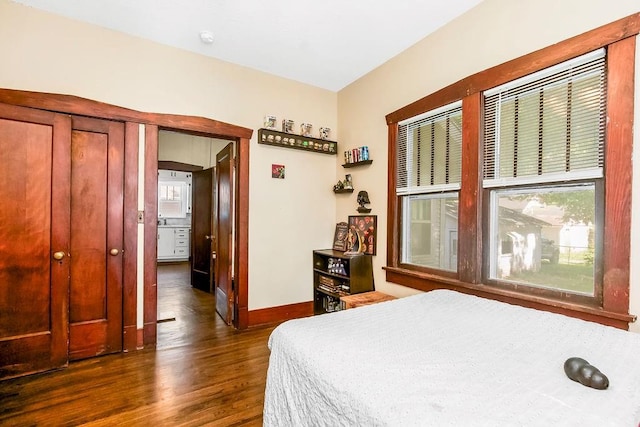 327 Parker Ave, Osawatomie, KS 66064 - bedroom featuring dark wood-style floors and baseboards
