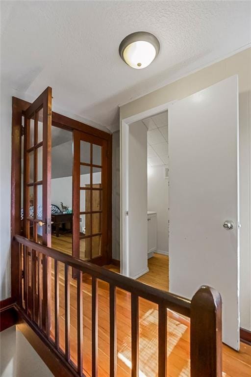 327 Parker Ave, Osawatomie, KS 66064 - corridor featuring wood finished floors, a textured ceiling, and french doors