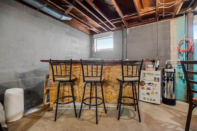 327 Parker Ave, Osawatomie, KS 66064 - indoor dry bar with concrete floors and concrete block wall