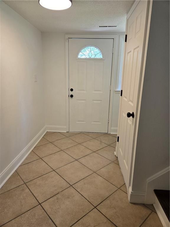 6302 E 120th Ter, Grandview, MO 64030 - entryway featuring light tile patterned flooring and baseboards