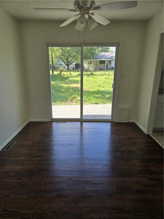 6302 E 120th Ter, Grandview, MO 64030 - unfurnished room featuring dark wood-style floors and ceiling fan