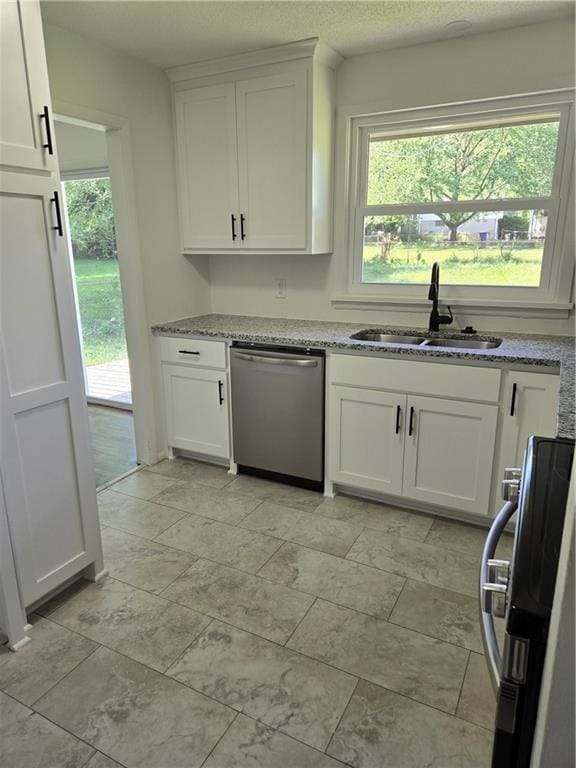 6302 E 120th Ter, Grandview, MO 64030 - kitchen featuring dishwasher, stove, white cabinetry, and light stone countertops