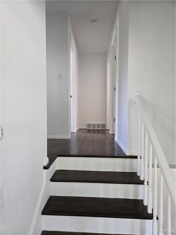 6302 E 120th Ter, Grandview, MO 64030 - stairway featuring wood finished floors and baseboards