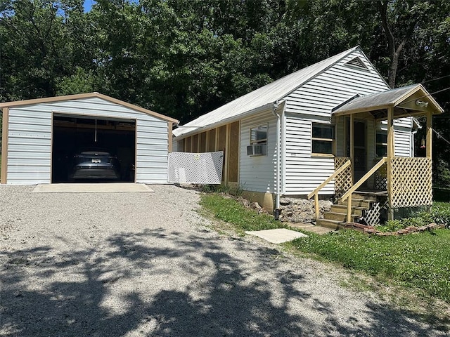 2332 Park Ln, Oak Grove, MO 64075 - view of front facade with driveway, an outdoor structure, a garage, and cooling unit