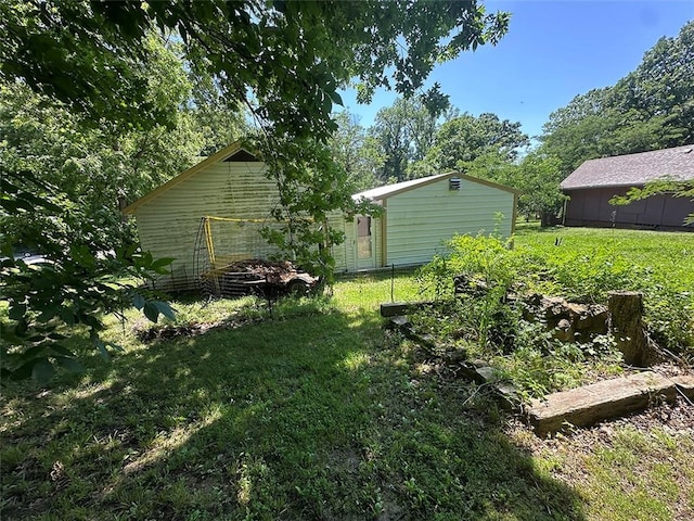 2332 Park Ln, Oak Grove, MO 64075 - view of green lawn with a vegetable garden