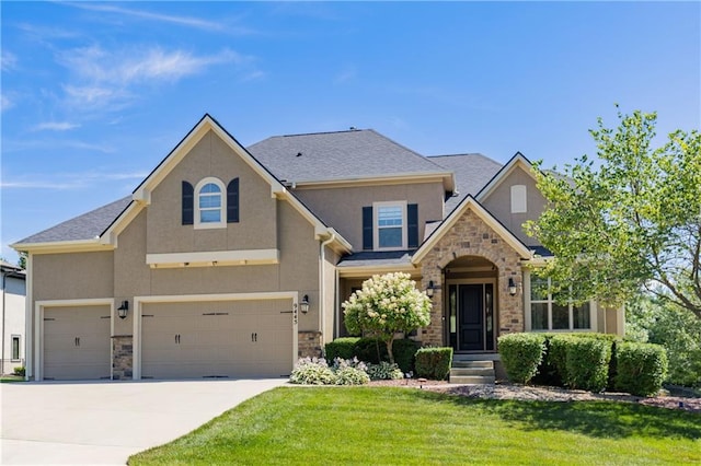 9445 W 157th Pl, Overland Park, KS 66221 - view of front of home with stucco siding, stone siding, a front lawn, concrete driveway, and an attached garage