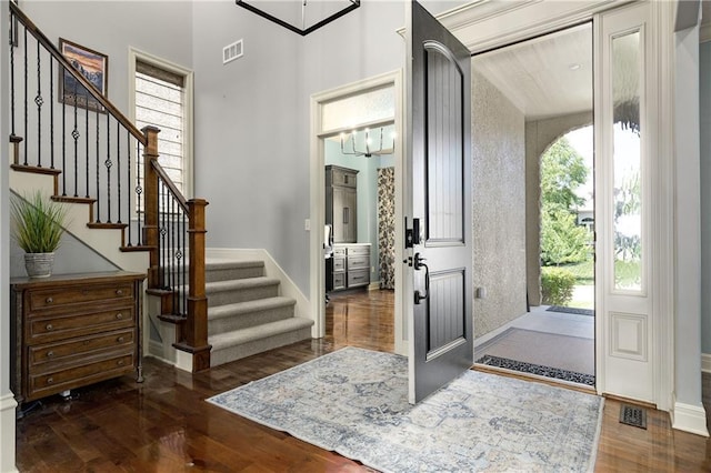9445 W 157th Pl, Overland Park, KS 66221 - entryway with wood finished floors, plenty of natural light, stairway, and a chandelier