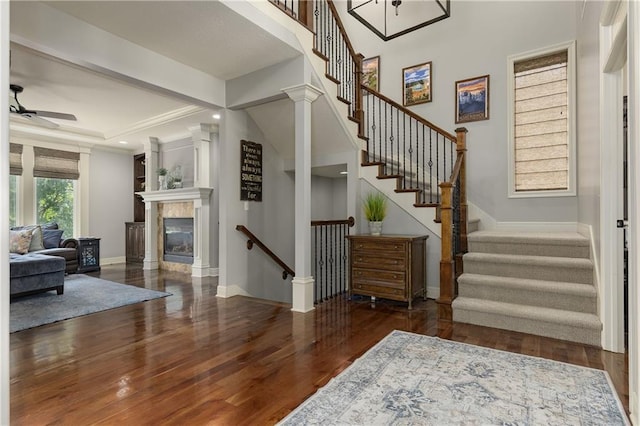 9445 W 157th Pl, Overland Park, KS 66221 - foyer entrance with wood finished floors, a ceiling fan, a tile fireplace, and stairs