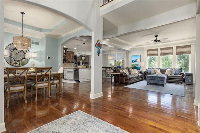 9445 W 157th Pl, Overland Park, KS 66221 - dining space with a chandelier, crown molding, ceiling fan, arched walkways, and dark wood finished floors