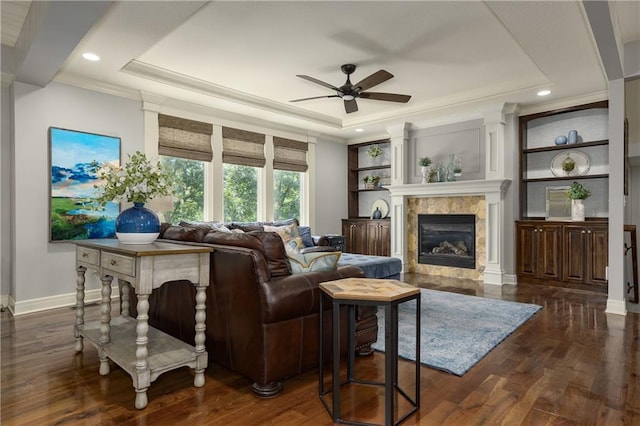 9445 W 157th Pl, Overland Park, KS 66221 - living area with a tray ceiling, ceiling fan, a premium fireplace, dark wood finished floors, and crown molding