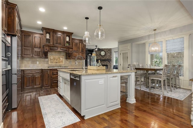 9445 W 157th Pl, Overland Park, KS 66221 - kitchen with dishwasher, dark wood-type flooring, decorative backsplash, stovetop, and recessed lighting