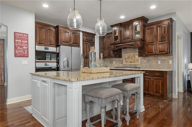 9445 W 157th Pl, Overland Park, KS 66221 - kitchen with stainless steel refrigerator with ice dispenser, tasteful backsplash, recessed lighting, dark wood finished floors, and a kitchen breakfast bar