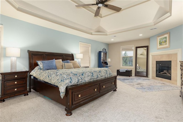 9445 W 157th Pl, Overland Park, KS 66221 - bedroom featuring a tray ceiling, light carpet, a tile fireplace, recessed lighting, and crown molding