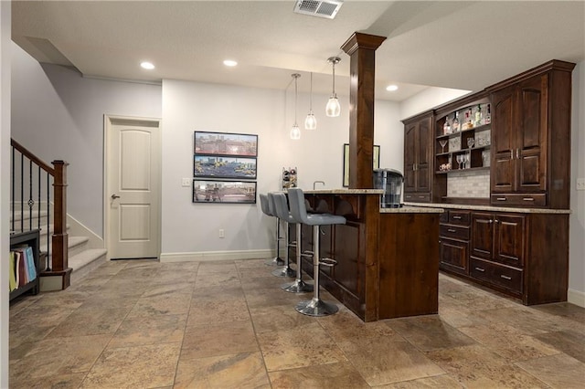 9445 W 157th Pl, Overland Park, KS 66221 - bar featuring stairs, stone tile floors, hanging light fixtures, decorative columns, and recessed lighting