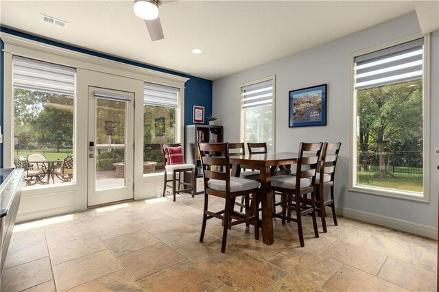 9445 W 157th Pl, Overland Park, KS 66221 - dining space with healthy amount of natural light, stone tile flooring, a ceiling fan, and recessed lighting
