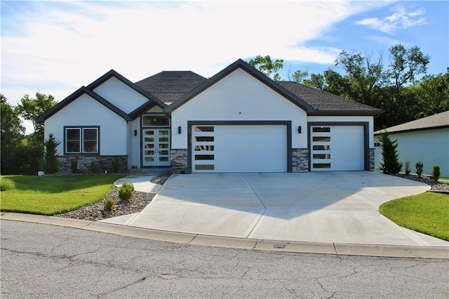 5443 N 101st Ter, Kansas City, KS 66109 - contemporary house featuring a garage, stone siding, a front yard, concrete driveway, and french doors