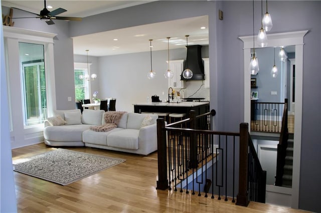 5443 N 101st Ter, Kansas City, KS 66109 - living room featuring light wood-style flooring, ceiling fan, a chandelier, and recessed lighting