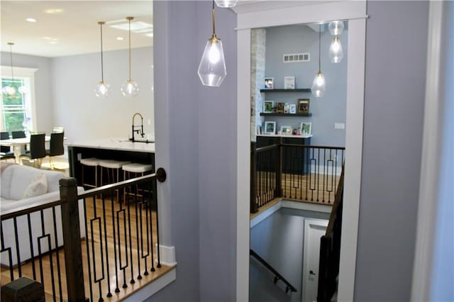 5443 N 101st Ter, Kansas City, KS 66109 - hallway with an upstairs landing and a sink