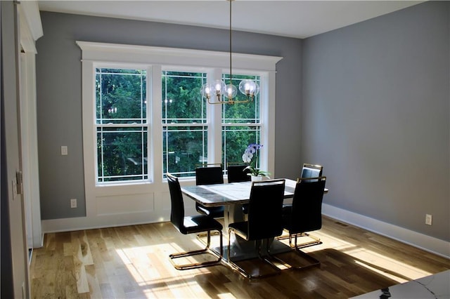 5443 N 101st Ter, Kansas City, KS 66109 - dining space featuring a chandelier, light wood-type flooring, and plenty of natural light