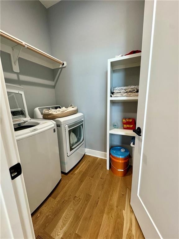 5443 N 101st Ter, Kansas City, KS 66109 - laundry area with washer and clothes dryer and wood finished floors