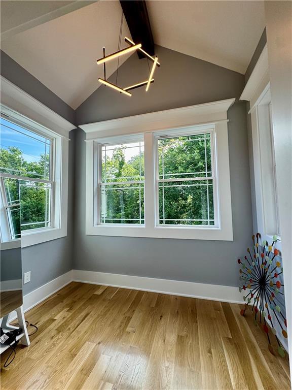 5443 N 101st Ter, Kansas City, KS 66109 - unfurnished room featuring light wood finished floors and a chandelier