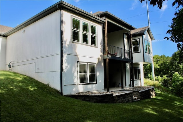 5443 N 101st Ter, Kansas City, KS 66109 - back of house with a balcony and a lawn