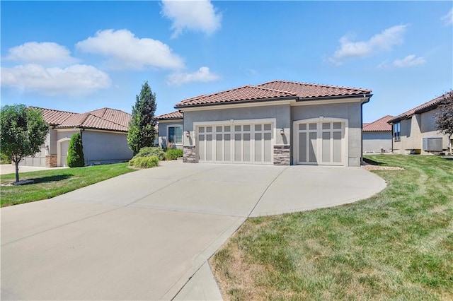 3912 SW Odell Dr, Lees Summit, MO 64082 - mediterranean / spanish house with stone siding, a garage, stucco siding, a tiled roof, and a front yard