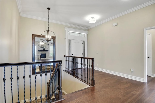 3912 SW Odell Dr, Lees Summit, MO 64082 - hallway with an upstairs landing, wood finished floors, crown molding, and a chandelier