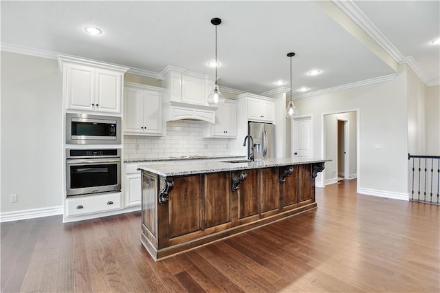 3912 SW Odell Dr, Lees Summit, MO 64082 - kitchen featuring appliances with stainless steel finishes, a kitchen breakfast bar, backsplash, white cabinetry, and dark wood-style flooring