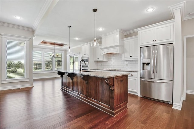 3912 SW Odell Dr, Lees Summit, MO 64082 - kitchen with stainless steel appliances, ornamental molding, dark wood-style floors, white cabinets, and premium range hood