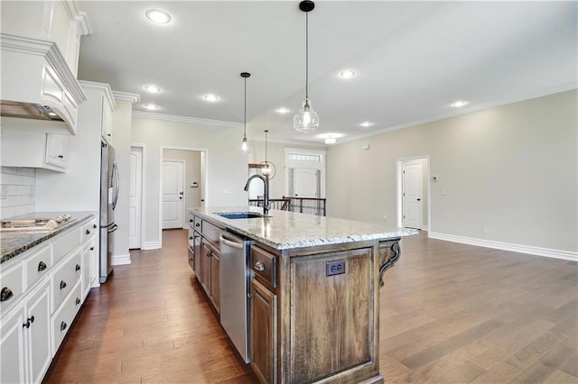 3912 SW Odell Dr, Lees Summit, MO 64082 - kitchen with ornamental molding, appliances with stainless steel finishes, white cabinets, custom exhaust hood, and a center island with sink
