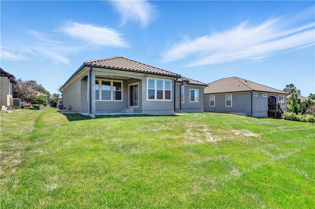 3912 SW Odell Dr, Lees Summit, MO 64082 - back of property featuring a tile roof, a yard, and stucco siding