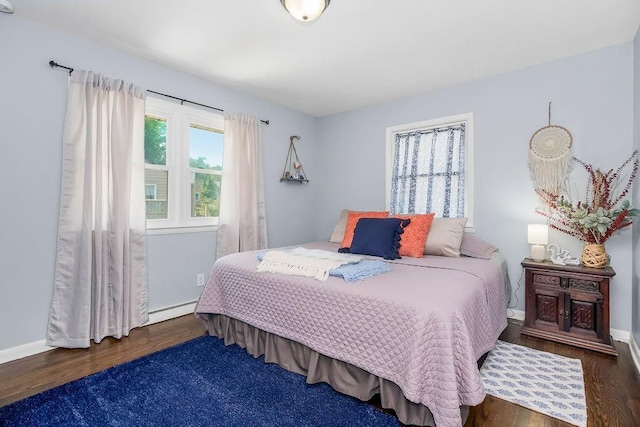 3006 S 39th St, Kansas City, KS 66106 - bedroom featuring wood finished floors and a baseboard radiator