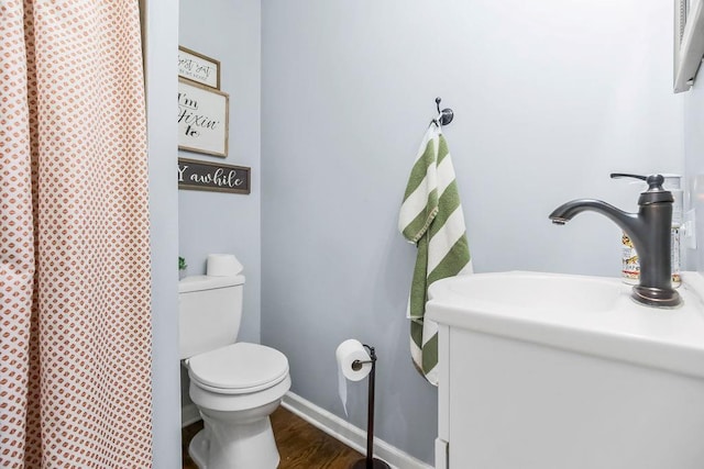 3006 S 39th St, Kansas City, KS 66106 - bathroom featuring curtained shower, wood finished floors, and vanity