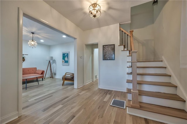 2606 Smart Ave, Kansas City, MO 64124 - foyer with a chandelier, stairway, wood finished floors, and recessed lighting